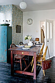 Satchel on chair back at kitchen table in contemporary London home, UK