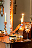 Vintage candle holders on wooden table with mirror in Walberton home, West Sussex, England, UK