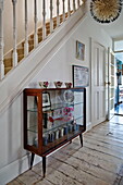 Vintage glass and wooden cabinet in family home, Bovey Tracey, Devon, England, UK