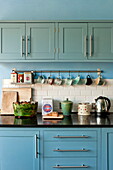 Homeware on counter in fitted kitchen of Bovey Tracey family home, Devon, England, UK