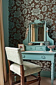 Upholstered chair at dressing table in bedroom of Bovey Tracey family home, Devon, England, UK