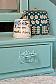 Vase and purse on painted dressing table in bedroom of Bovey Tracey family home, Devon, England, UK