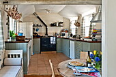 Navy blue range oven in split level kitchen of Suffolk farmhouse, England, UK