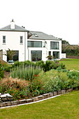 Lawned exterior of detached house, Cornwall England, UK