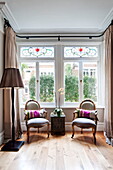 Antique chairs in window of Middlesex family home, London, England, UK