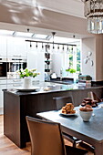 Cakes on table in open plan kitchen dining room of Middlesex family home, London, England, UK