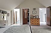 Master bedroom with en suite facilities and dressing room in roof space of London home, England, UK
