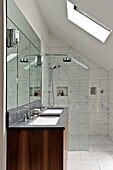Shower screen and double basins in wet room of London home, England, UK