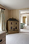 Old fashioned dolls house at doorway in Suffolk country house, England, UK