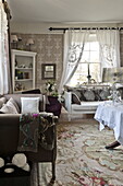 Bestickte Gardinen mit Sofas im Wohnzimmer eines Landhauses in Bury St Edmunds, Suffolk, England, Vereinigtes Königreich