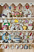 Chinaware in kitchen dresser in London home, England, UK