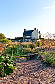 Gravel garden and rural farmhouse exterior in Blagdon, Somerset, England, UK