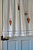 Linen bathroom door curtain with hearts in Tregaron home Wales UK