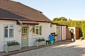 Entrance of single storey holiday home with paved driveway Cornwall UK
