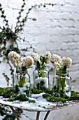 Cut flowers in jam jars in London courtyard England UK