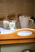 Mug with loveheart and eggcups on wooden tray in Stamford kitchen Lincolnshire England UK