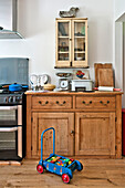 Toy truck with wooden sideboard and glass-fronted cabinet in Cambridge cottage England UK