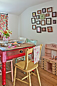 Gerahmtes Kunstwerk mit bemaltem Küchentisch und Stühlen in einem Landhaus in Cambridge England UK