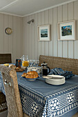 Breakfast table with wicker dining chairs in Penzance farmhouse Cornwall England UK