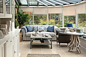 Striped sofa in conservatory extension of Penzance farmhouse Cornwall England UK