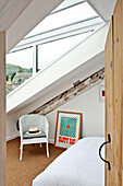 Sunhat on wicker chair in dormer window of family townhouse Cornwall England UK