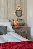 Fairylights on circular mirror at bedside in Penzance farmhouse Cornwall UK