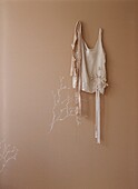 Brown paper on wall with chalk drawing and delicate camisole top hanging