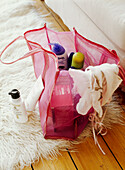 Girl's wash bag open on a shag pile rug