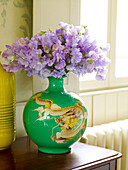 Lila Erbsen (Lathyrus odoratus) in grüner orientalischer Vase