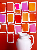 White ceramic jug with assorted paint samples