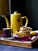 Digestive biscuits and coffee pot with mug and pink tartan