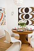 Dining table with 1960s style retro print in Manchester family home, England, UK