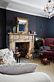 Lit candles in fireplace of dark grey living room in Tenterden family home, Kent, England, UK