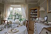 White dining room set for Christmas dinner in Tenterden home, Kent, England, UK