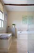 Cream bathroom with grey side cabinet and window seat in Etchingham farmhouse East Sussex England UK