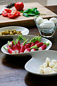 Radishes and olives in serving bowls in kitchen of Wandsworth home London England UK