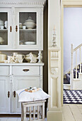 Crockery on kitchen dresser with view through doorway in Victorian villa Kent England UK