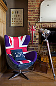 Union Jack chair with tripod at exposed brick fireplace in Victorian villa Kent England UK