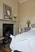 White double bed with original fireplace in Hackney home London England UK