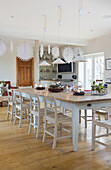 Table with painted chairs in dining room of Faversham home Kent England UK