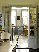 View through double doors to kitchen in East Sussex country house England UK