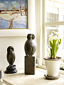 Crocus and owl statues on windowsill in Nottinghamshire home England UK