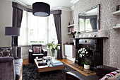 Original fireplace in muted living room of contemporary London home, England, UK