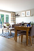 Dining table and chairs in open plan living room of Cambridgeshire home UK
