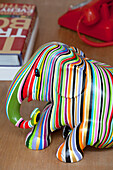Striped elephant on coffee table of contemporary London home, UK