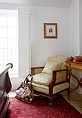 Wicker armchair in corner of bedroom in Wepham home Sussex UK