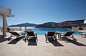 Four sunloungers at poolside in luxury holiday villa, Republic of Turkey