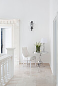 Side table and chair in white hallway landing, holiday villa, Republic of Turkey