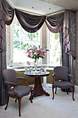 Window detail with matching chairs in contemporary London townhouse, UK