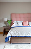 Red and white checked upholstered headboard in Cotswolds bedroom UK